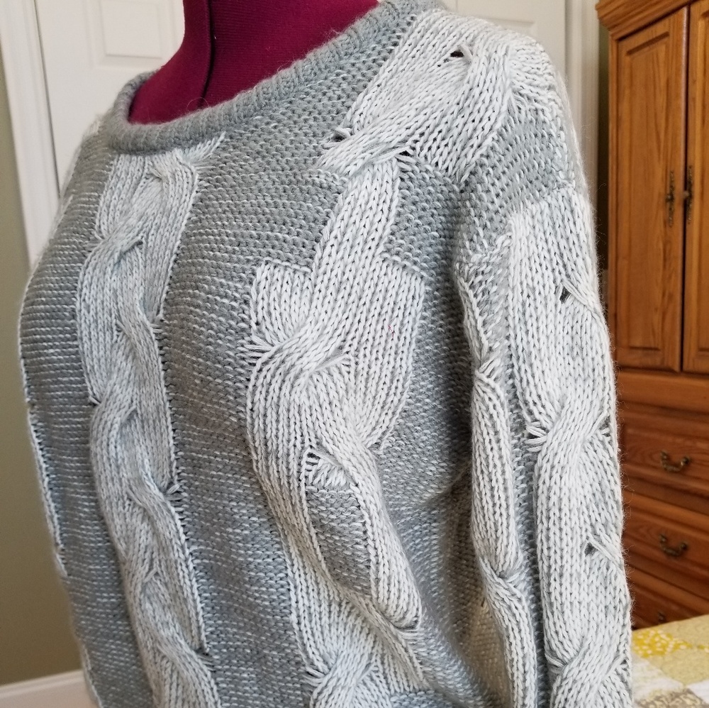Gray and white sweater with braided design